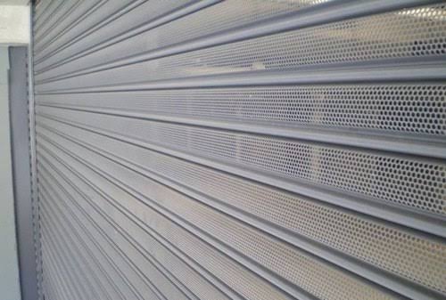 Perforated roller shutter door