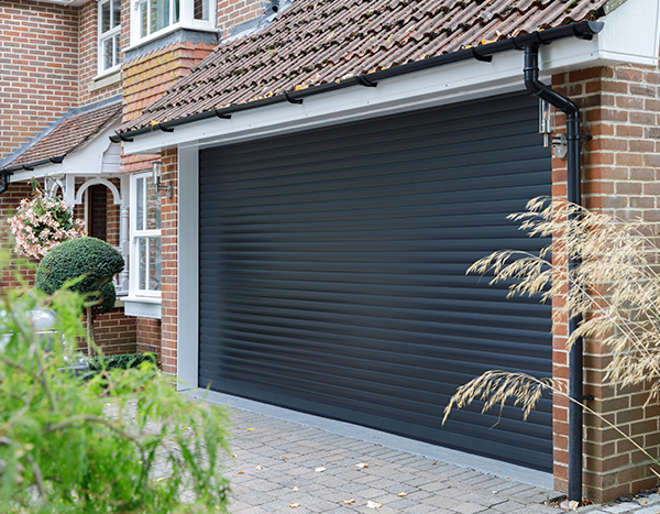 White roll-up garage door fitted to a residential double garage